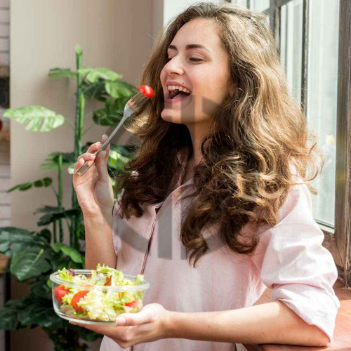 mutfakta yemek yiyen mutlu kiz salata gorseli