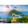 Sari elbiseli kadin deniz manzarasina karsi